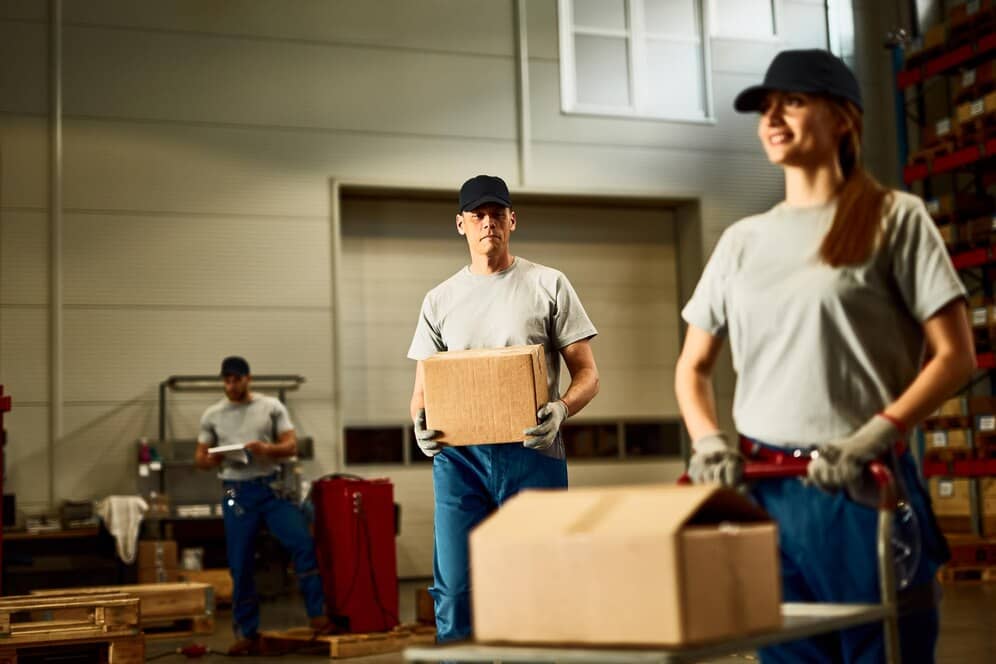 mid-adult-worker-carrying-cardboard-bo