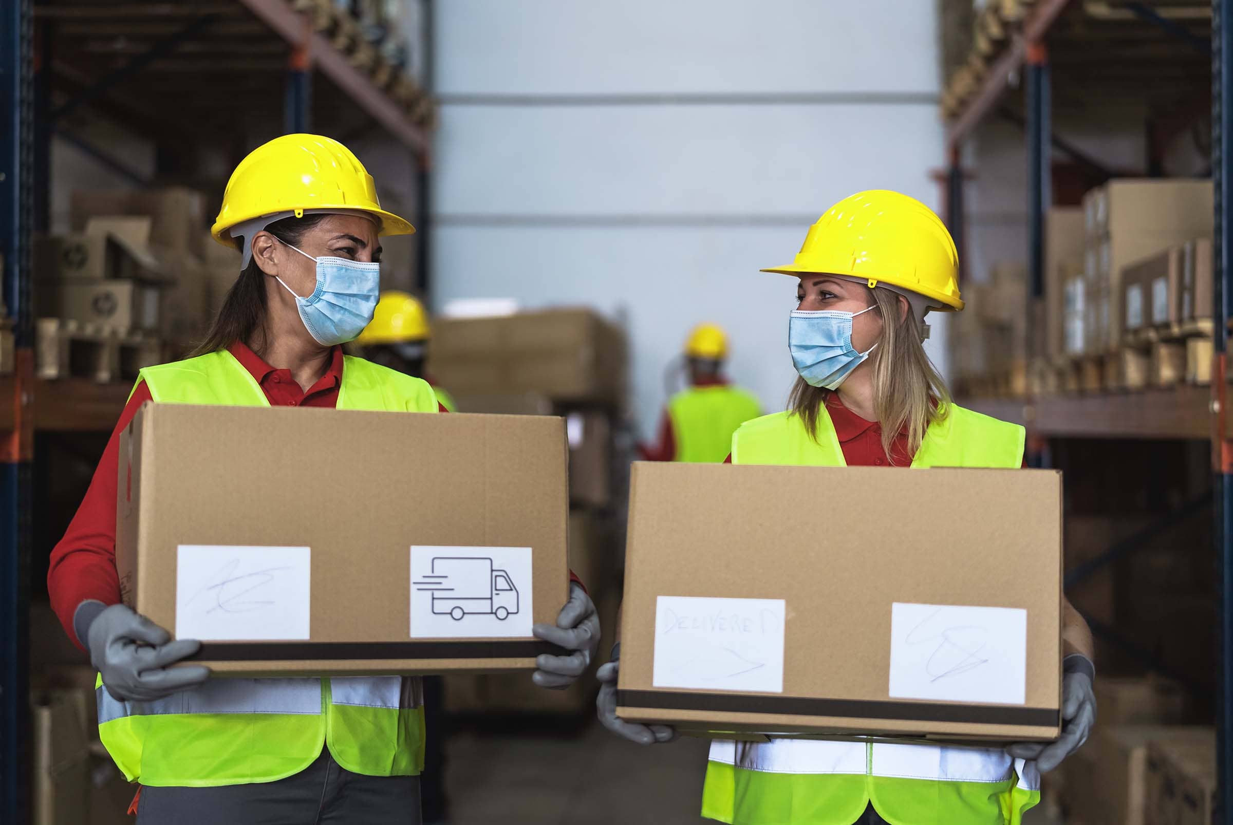 team-working-in-warehouse-loading-delivery-boxes-w